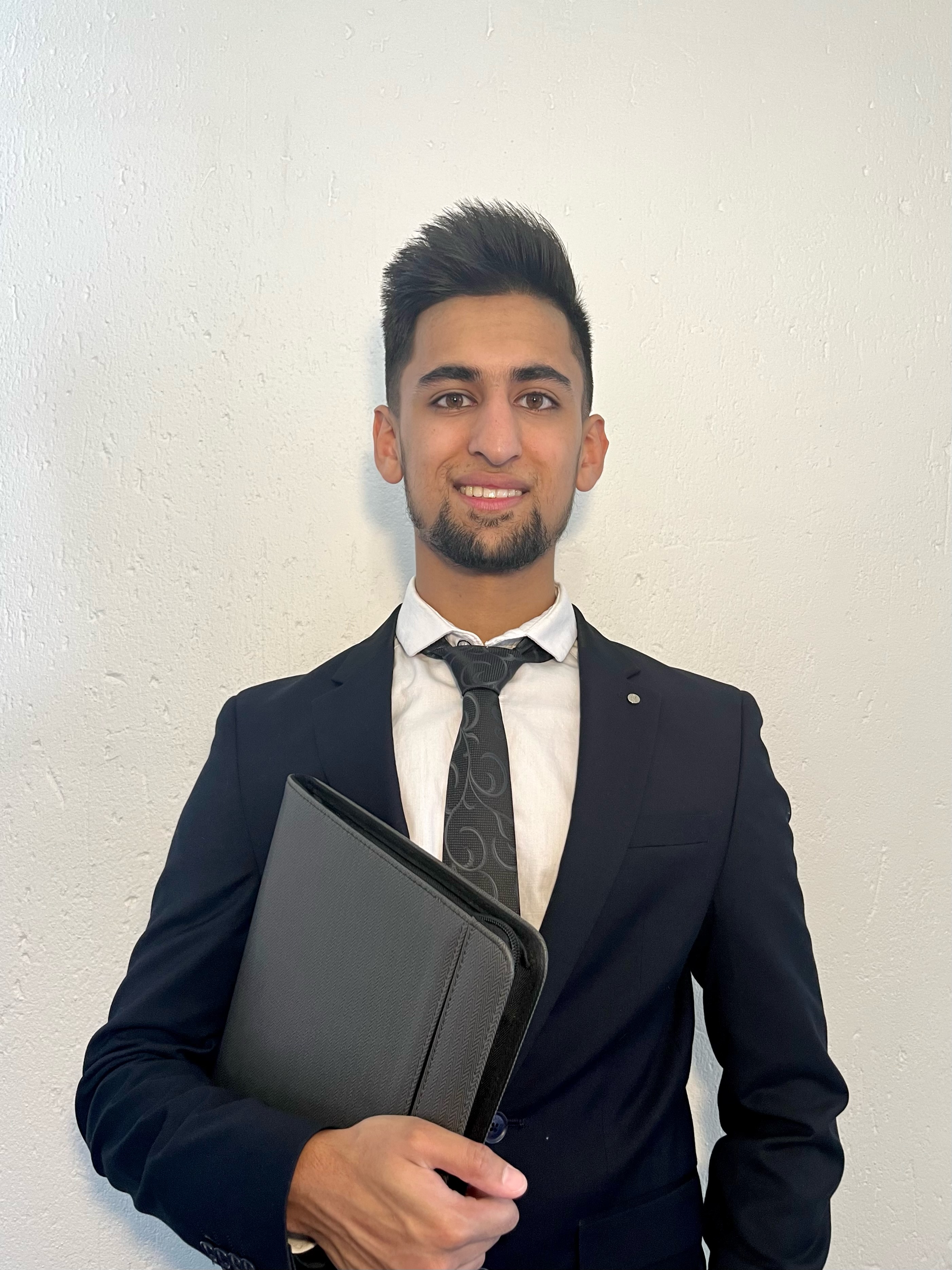 Abdullah Hassan making peace sign in contemporary workspace